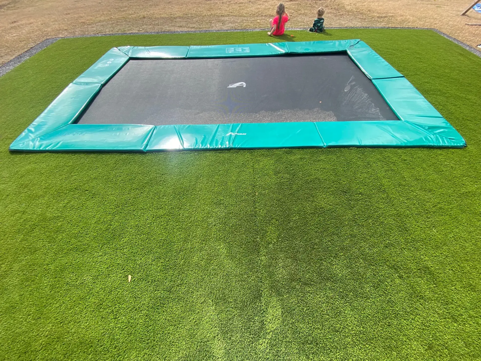 customer installed green inground trampoline