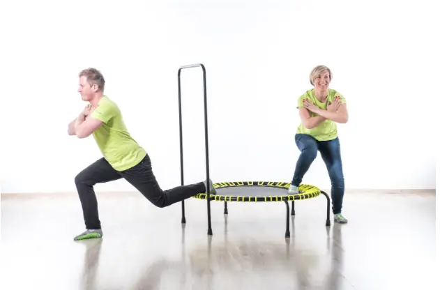 Adults squatting on Akrobat Speed Bouncer